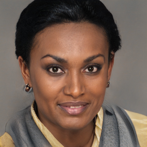 Joyful black young-adult female with short  brown hair and brown eyes