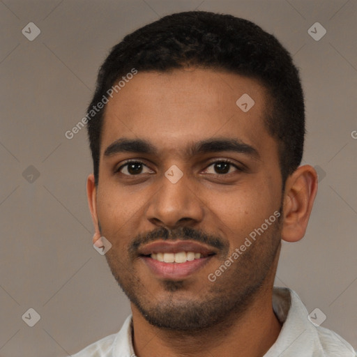 Joyful black young-adult male with short  black hair and brown eyes