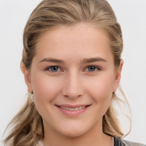 Joyful white young-adult female with long  brown hair and grey eyes