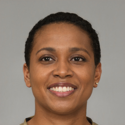 Joyful black young-adult female with short  black hair and brown eyes