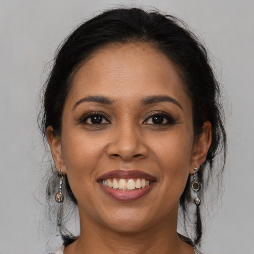 Joyful latino young-adult female with medium  brown hair and brown eyes