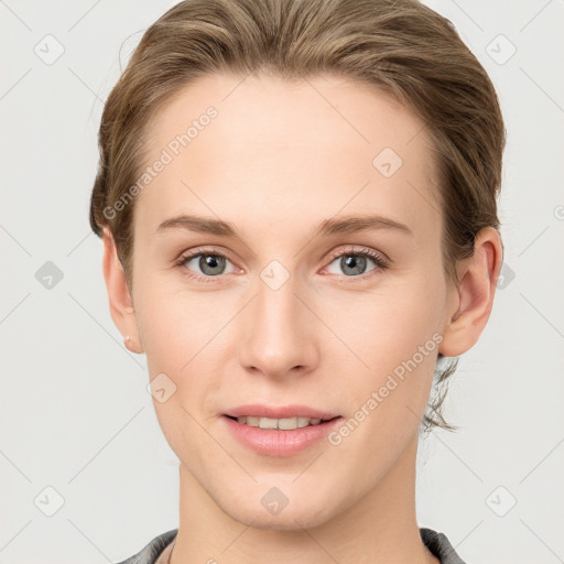 Joyful white young-adult female with short  brown hair and grey eyes