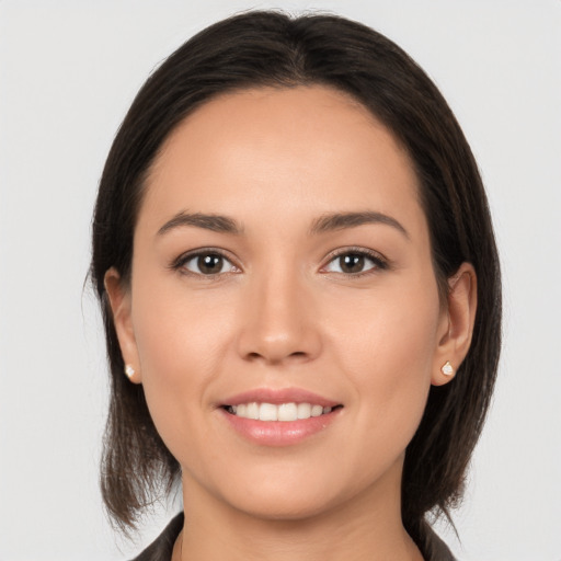 Joyful white young-adult female with medium  brown hair and brown eyes