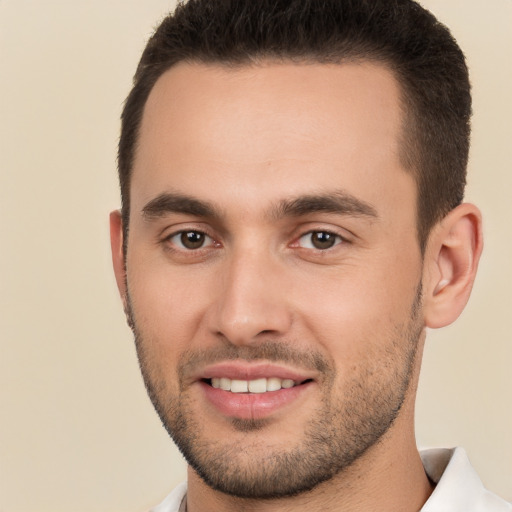 Joyful white young-adult male with short  brown hair and brown eyes