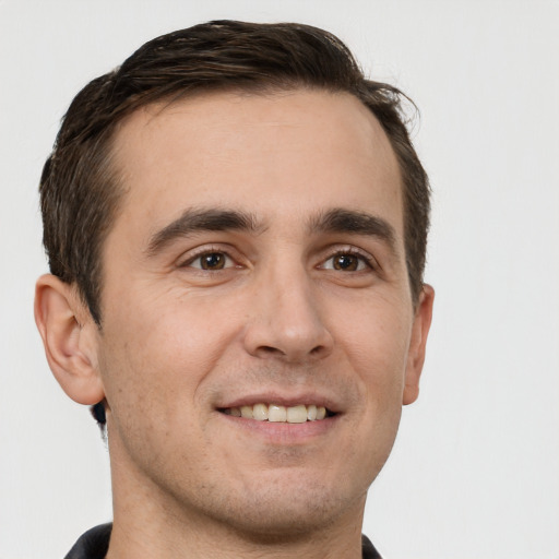 Joyful white young-adult male with short  brown hair and brown eyes