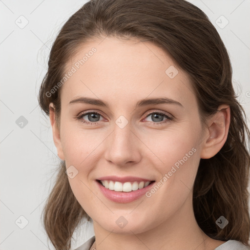 Joyful white young-adult female with medium  brown hair and grey eyes