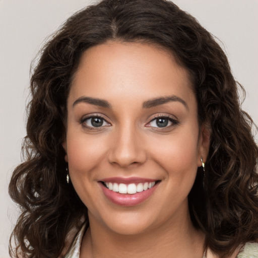 Joyful white young-adult female with long  brown hair and brown eyes