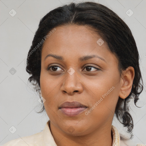 Joyful black adult female with medium  brown hair and brown eyes