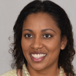 Joyful black young-adult female with medium  brown hair and brown eyes