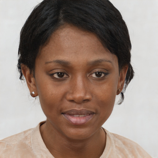 Joyful black young-adult female with short  brown hair and brown eyes