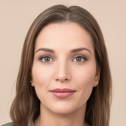 Joyful white young-adult female with long  brown hair and green eyes