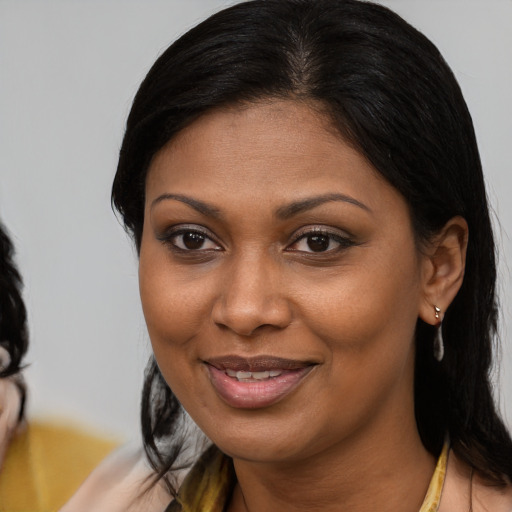 Joyful black young-adult female with medium  brown hair and brown eyes