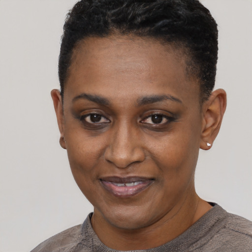 Joyful black young-adult female with short  black hair and brown eyes