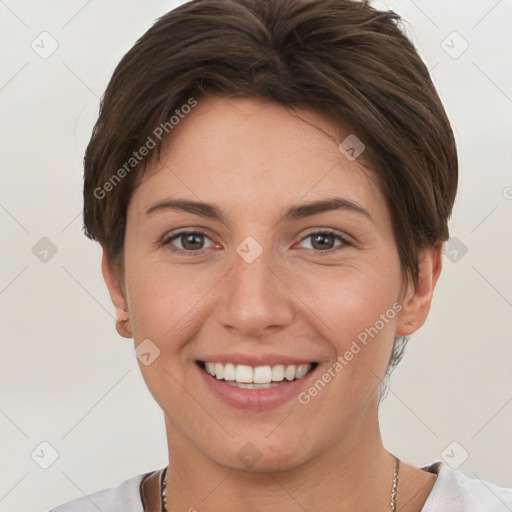 Joyful white young-adult female with short  brown hair and grey eyes