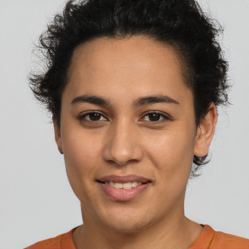 Joyful latino young-adult female with short  brown hair and brown eyes