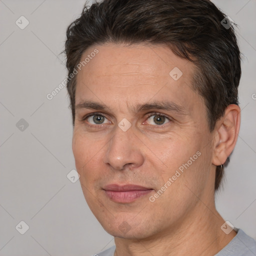 Joyful white adult male with short  brown hair and brown eyes