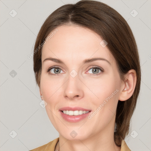 Joyful white young-adult female with medium  brown hair and grey eyes