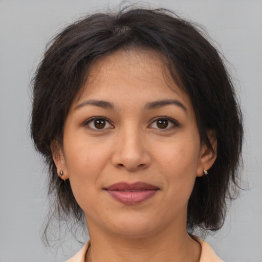 Joyful asian adult female with medium  brown hair and brown eyes