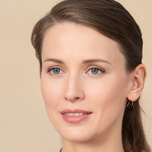 Joyful white young-adult female with long  brown hair and brown eyes