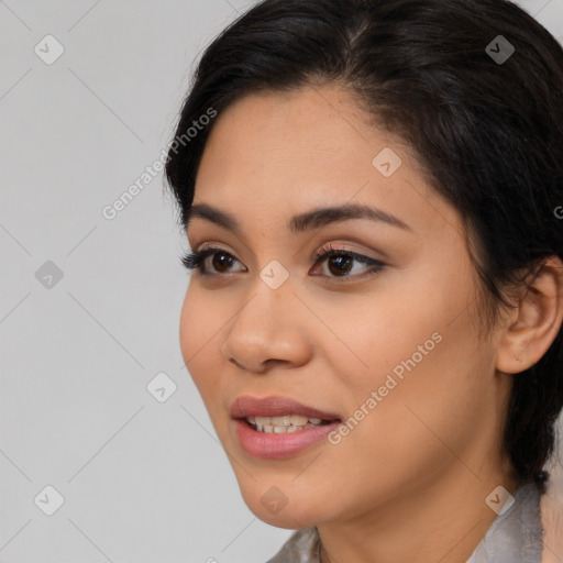 Joyful latino young-adult female with medium  brown hair and brown eyes