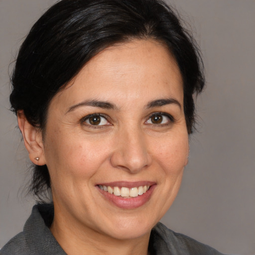 Joyful white adult female with medium  brown hair and brown eyes