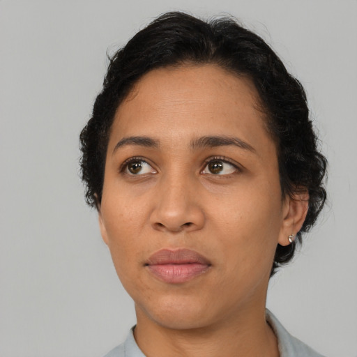 Neutral latino adult female with short  black hair and brown eyes