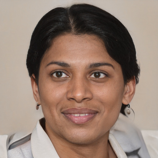 Joyful latino adult female with short  brown hair and brown eyes