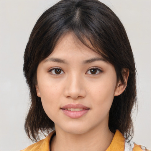 Joyful asian young-adult female with medium  brown hair and brown eyes