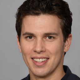 Joyful white adult male with short  brown hair and brown eyes