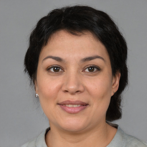 Joyful white adult female with short  brown hair and brown eyes