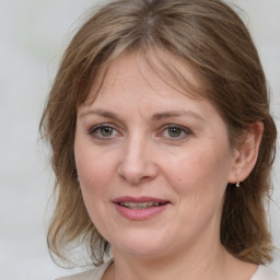 Joyful white young-adult female with medium  brown hair and blue eyes