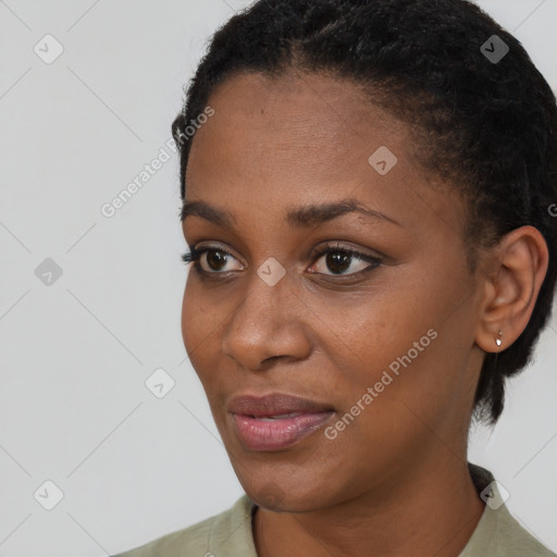 Joyful black young-adult female with short  black hair and brown eyes