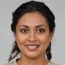 Joyful latino young-adult female with medium  brown hair and brown eyes