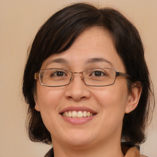 Joyful white adult female with medium  brown hair and brown eyes