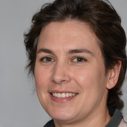 Joyful white adult female with medium  brown hair and brown eyes