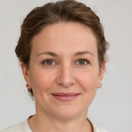 Joyful white adult female with short  brown hair and grey eyes