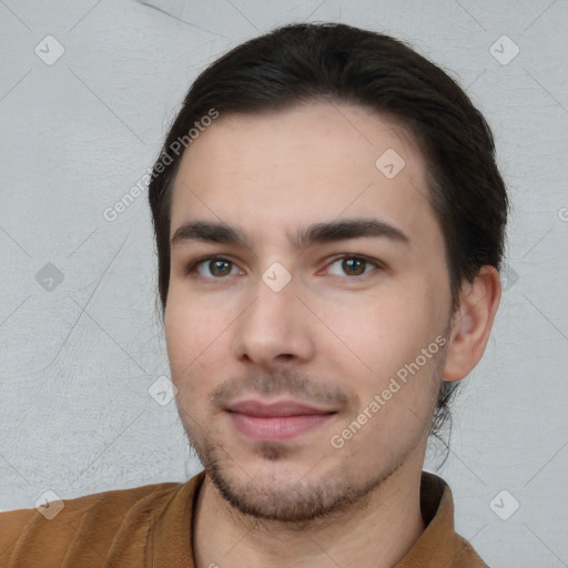 Joyful white young-adult male with short  black hair and brown eyes