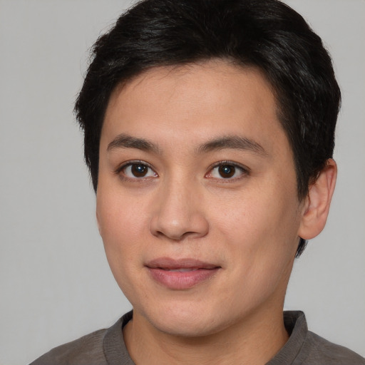 Joyful asian young-adult male with short  brown hair and brown eyes