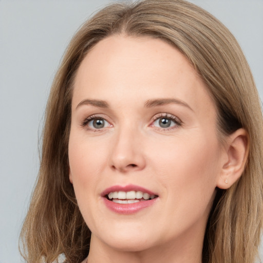 Joyful white young-adult female with long  brown hair and grey eyes