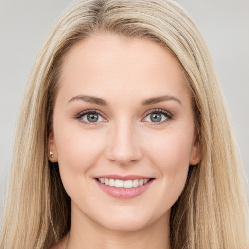 Joyful white young-adult female with long  brown hair and blue eyes