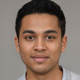 Joyful latino young-adult male with short  black hair and brown eyes