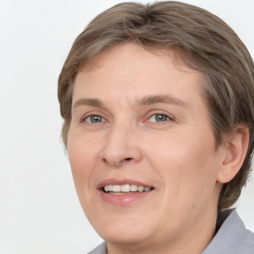 Joyful white adult female with medium  brown hair and grey eyes