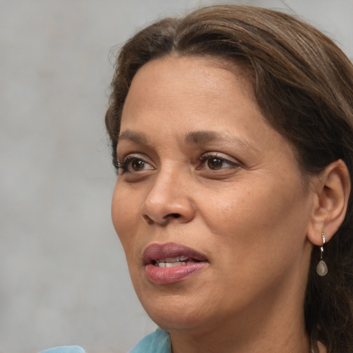 Joyful white adult female with medium  brown hair and brown eyes