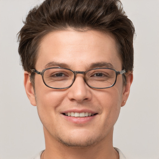 Joyful white young-adult male with short  brown hair and grey eyes