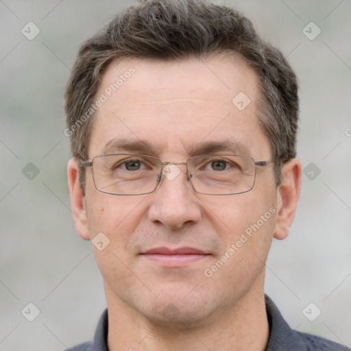 Joyful white adult male with short  brown hair and grey eyes