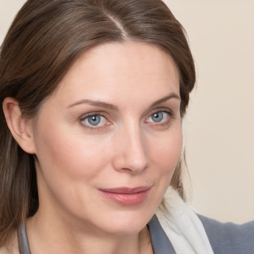 Joyful white young-adult female with medium  brown hair and blue eyes