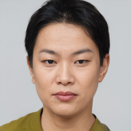 Joyful asian young-adult female with short  brown hair and brown eyes