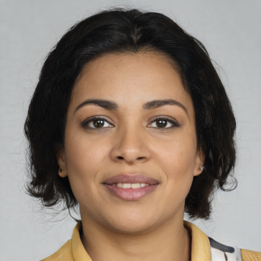 Joyful latino young-adult female with medium  brown hair and brown eyes
