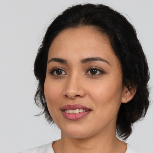 Joyful white young-adult female with medium  black hair and brown eyes