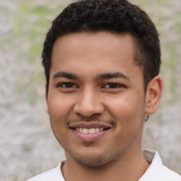 Joyful latino young-adult male with short  brown hair and brown eyes